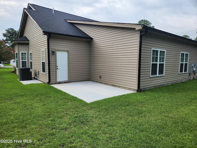 back of property featuring central air condition unit, a patio area, and a yard