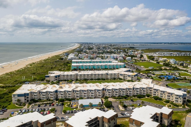 bird's eye view featuring a water view and a beach view