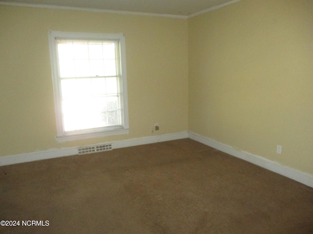 unfurnished room with carpet floors and crown molding