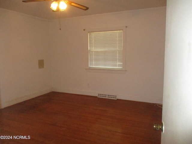 spare room featuring dark hardwood / wood-style flooring, ceiling fan, and crown molding