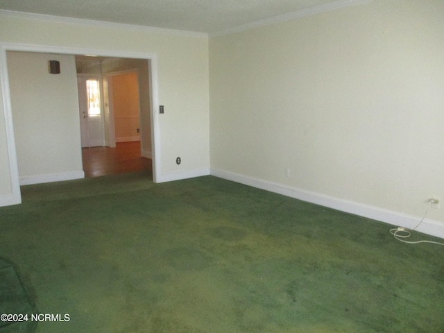 carpeted spare room featuring ornamental molding