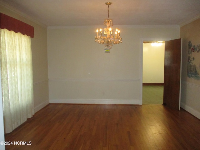 empty room with crown molding, dark hardwood / wood-style flooring, and a chandelier