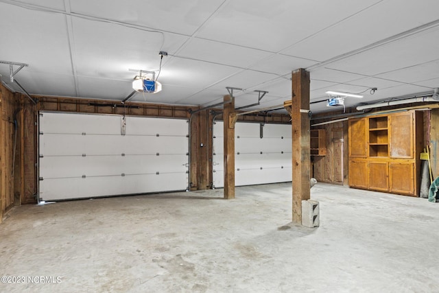 garage featuring wooden walls and a garage door opener