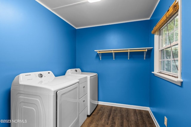 washroom featuring dark hardwood / wood-style floors, ornamental molding, and washing machine and clothes dryer