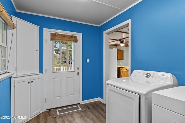 laundry area with ceiling fan, dark wood-type flooring, cabinets, crown molding, and washer / dryer