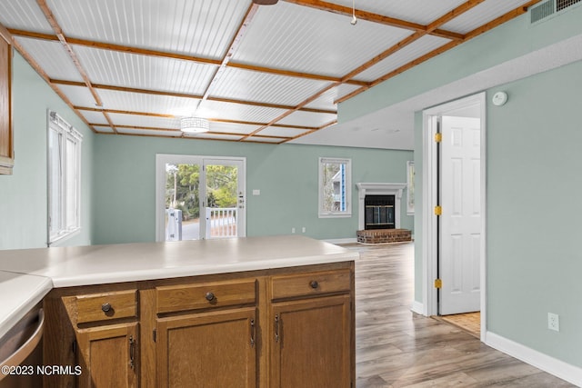 kitchen featuring a fireplace and light hardwood / wood-style floors