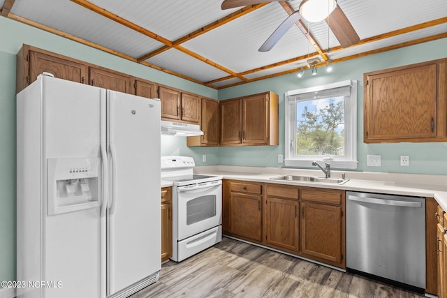 kitchen with light wood-type flooring, white appliances, ceiling fan, and sink