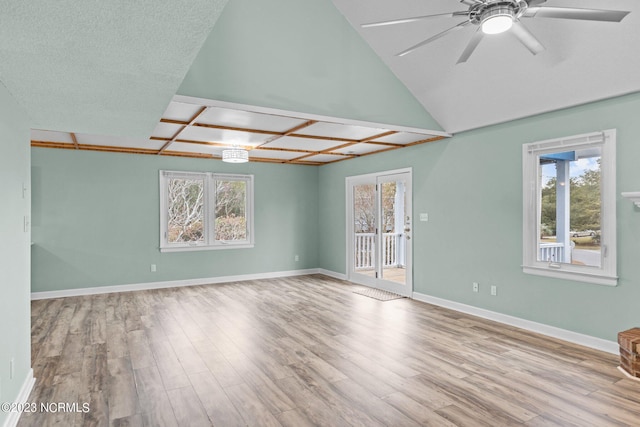 unfurnished room featuring ceiling fan, light wood-type flooring, and a textured ceiling