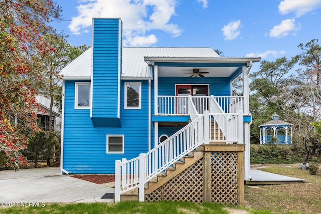 back of house featuring a gazebo, ceiling fan, and covered porch