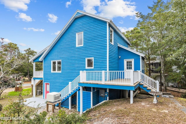 back of property with a patio area and a wooden deck