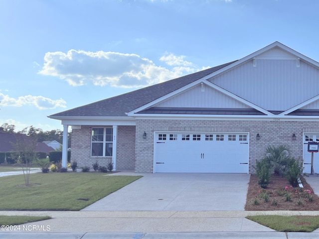 view of front of home with a front lawn and a garage