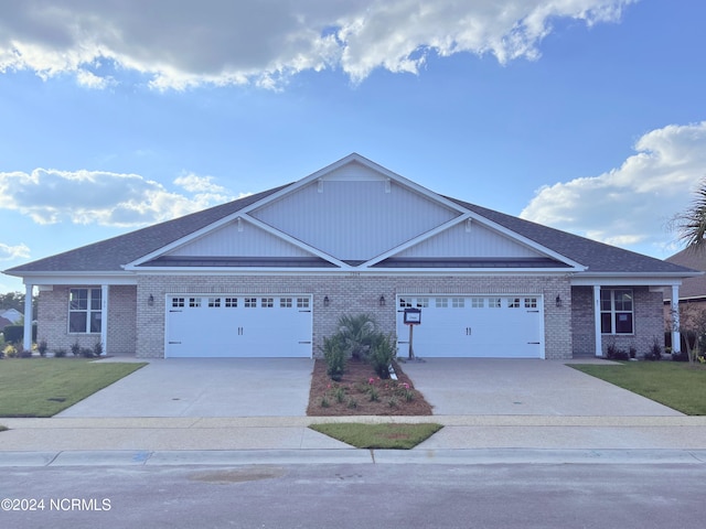 ranch-style house featuring a garage and a front lawn