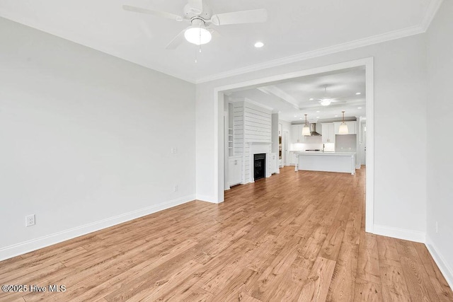 unfurnished living room with crown molding, ceiling fan, and light wood-type flooring