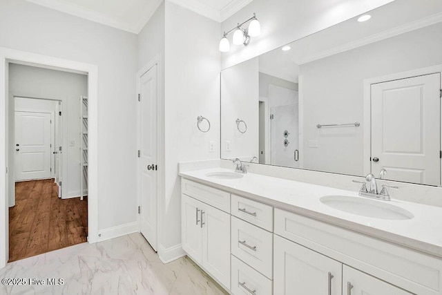 bathroom featuring walk in shower, ornamental molding, and vanity