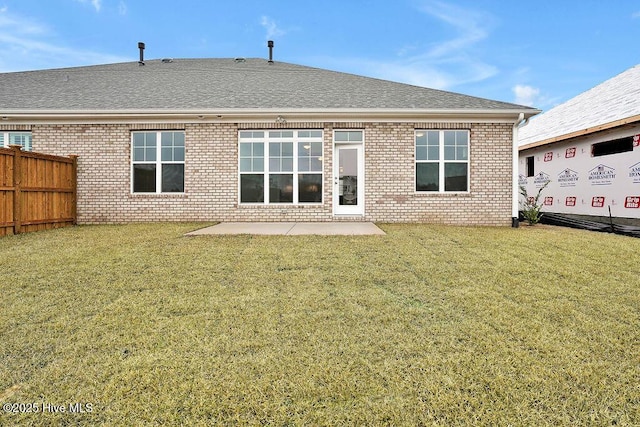 back of house with a yard and a patio area