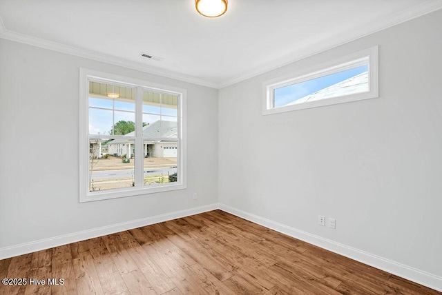 unfurnished room featuring wood-type flooring and ornamental molding