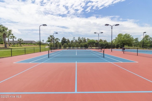 view of tennis court featuring basketball hoop