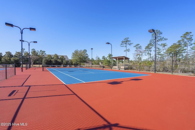 view of tennis court with basketball hoop