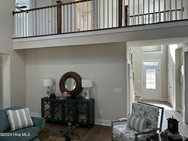 interior space with hardwood / wood-style flooring and a towering ceiling