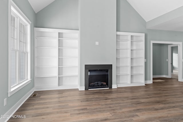 unfurnished living room featuring built in shelves, high vaulted ceiling, and dark hardwood / wood-style floors