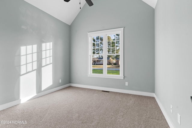 carpeted empty room featuring plenty of natural light, high vaulted ceiling, and ceiling fan