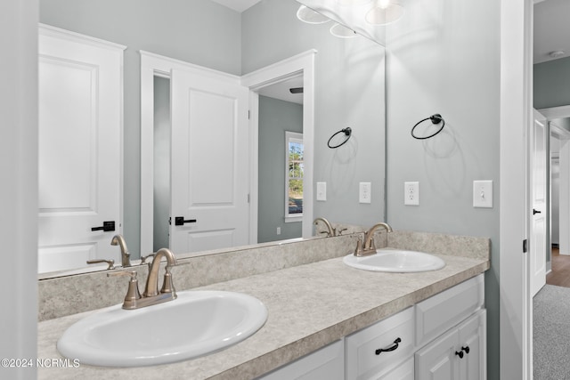 bathroom with dual sinks and large vanity