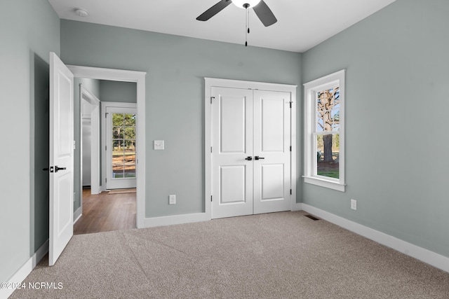 unfurnished bedroom with a closet, light carpet, and ceiling fan