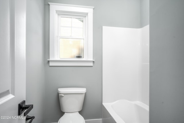 bathroom featuring shower / bath combination and toilet