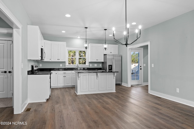 kitchen featuring hanging light fixtures, dark wood-type flooring, a center island, and white cabinets