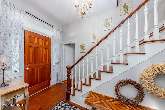 entrance foyer with wood-type flooring and an inviting chandelier