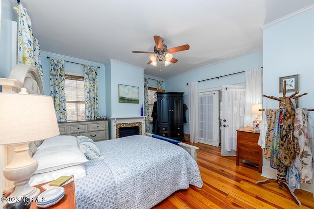 bedroom featuring ceiling fan, light hardwood / wood-style floors, and crown molding