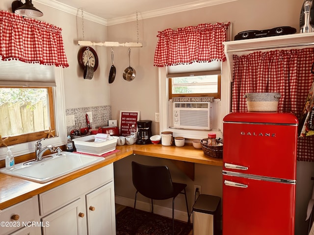 home office featuring cooling unit, ornamental molding, and sink