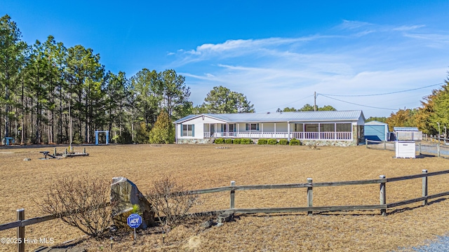 view of front of house featuring an outbuilding and a porch