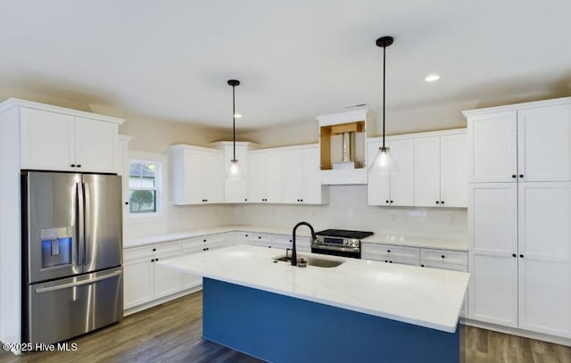 kitchen with appliances with stainless steel finishes, dark wood-type flooring, a sink, and white cabinets