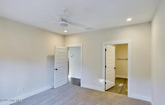 unfurnished bedroom featuring carpet floors, baseboards, and visible vents