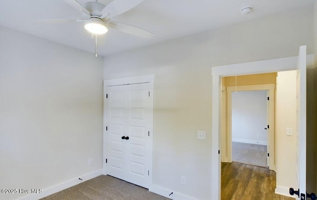 unfurnished bedroom featuring carpet, baseboards, and a closet