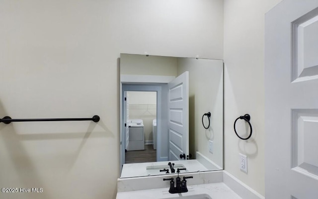 bathroom with a sink and baseboards