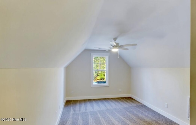 bonus room featuring lofted ceiling, ceiling fan, carpet flooring, visible vents, and baseboards