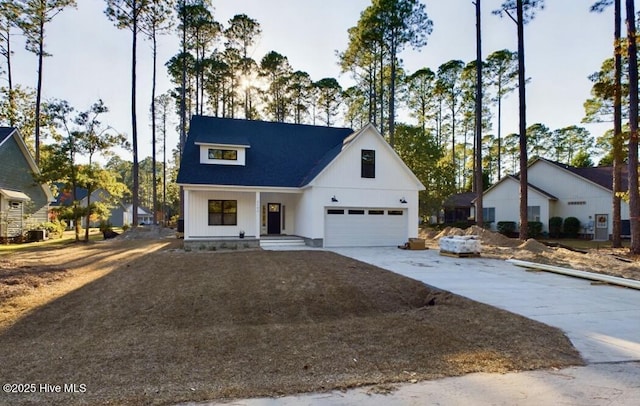 modern farmhouse with a garage and driveway