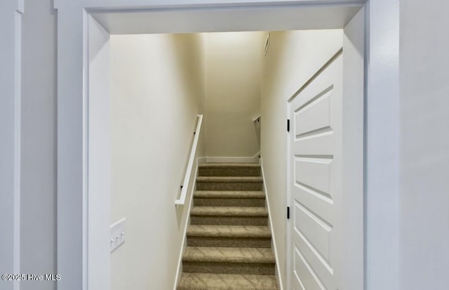 staircase with carpet floors and baseboards