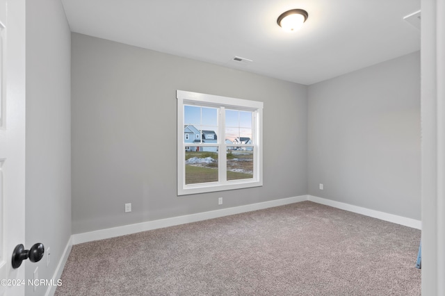 unfurnished room featuring light carpet