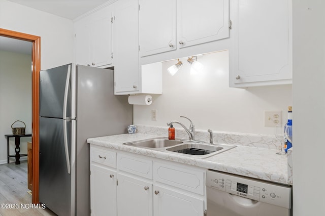 kitchen featuring light wood-type flooring, white cabinetry, and dishwasher