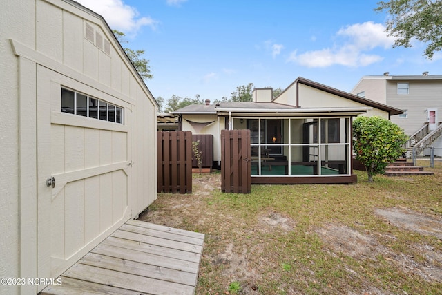 rear view of property with a sunroom