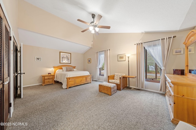 carpeted bedroom featuring ceiling fan, a closet, and lofted ceiling