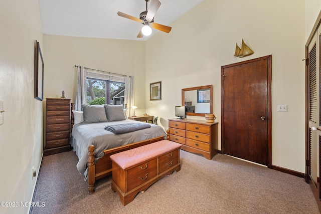 bedroom featuring high vaulted ceiling, a closet, ceiling fan, and carpet floors