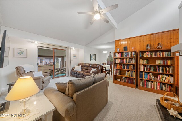 living room with high vaulted ceiling and carpet