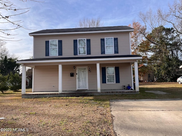 view of front property featuring a front lawn and covered porch