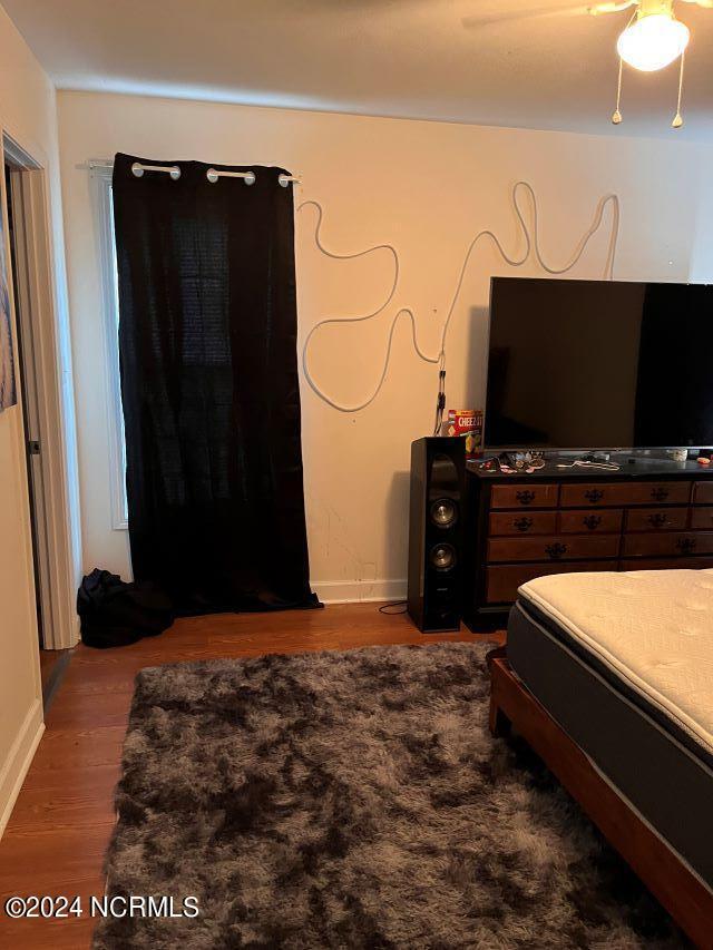 bedroom with hardwood / wood-style floors and ceiling fan