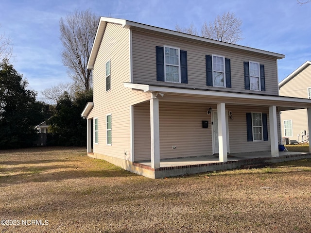 view of front of house with a front yard and covered porch