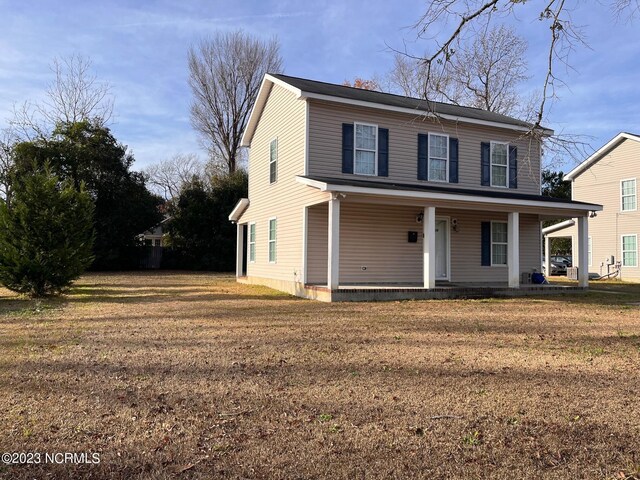 front facade featuring a porch and a front yard